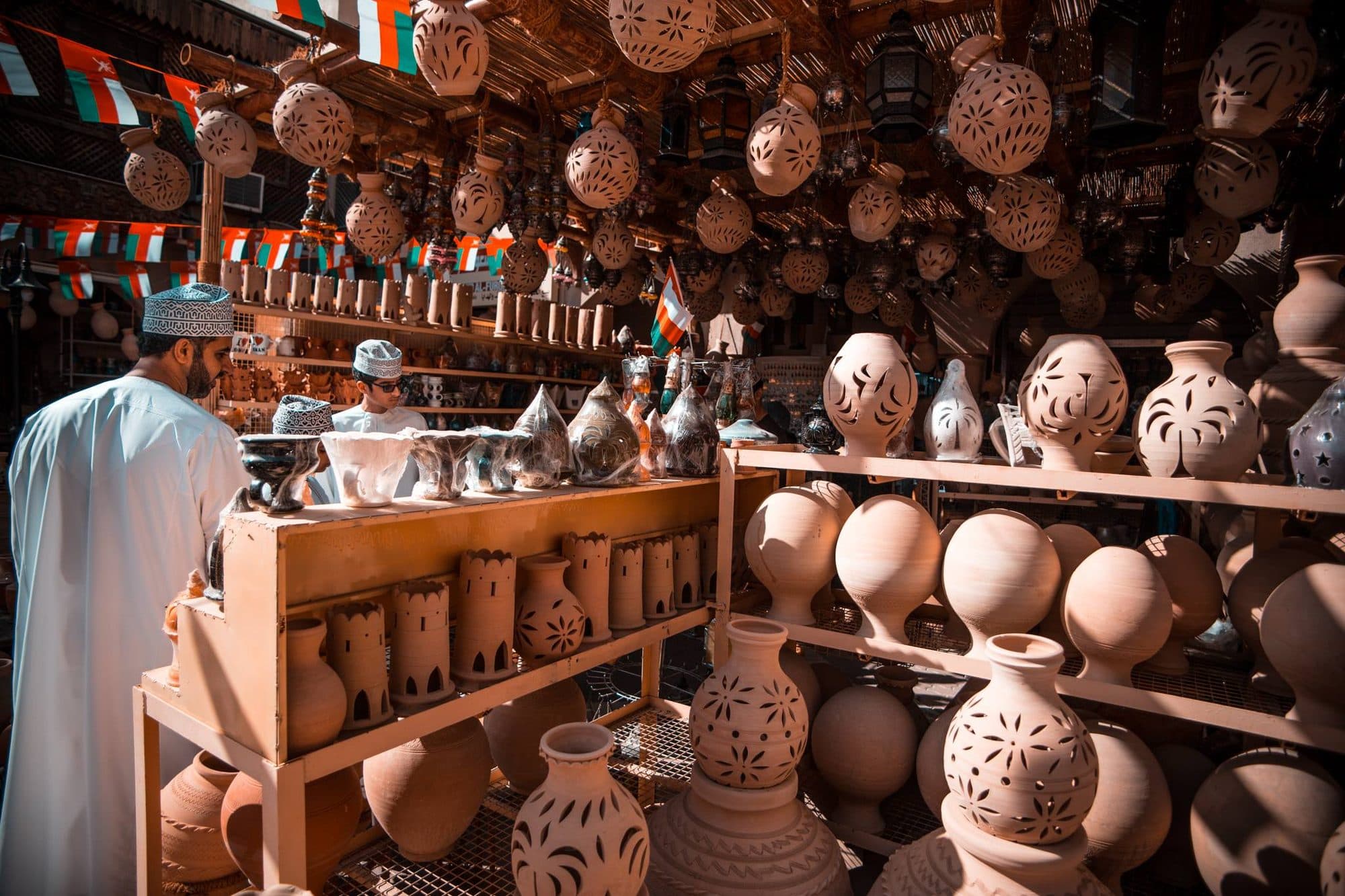 Clay pots stacked high in a pottery shop in Nizwa souq