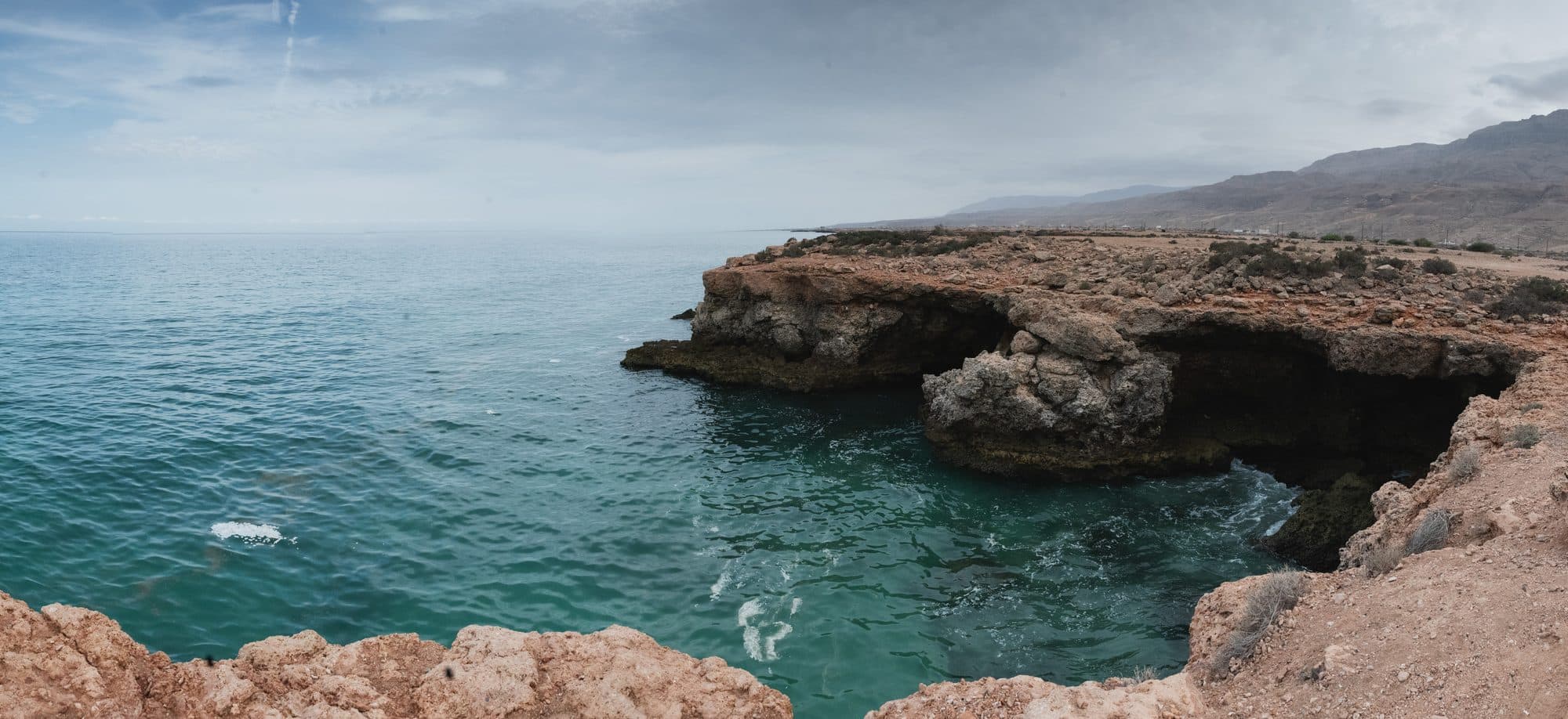 Turquoise water below the limestone cliffs of the coast near Tiwi